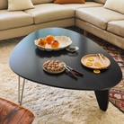 The Noguchi Rudder Coffee Table from Herman Miller in Black Ebony Maple in a living room.