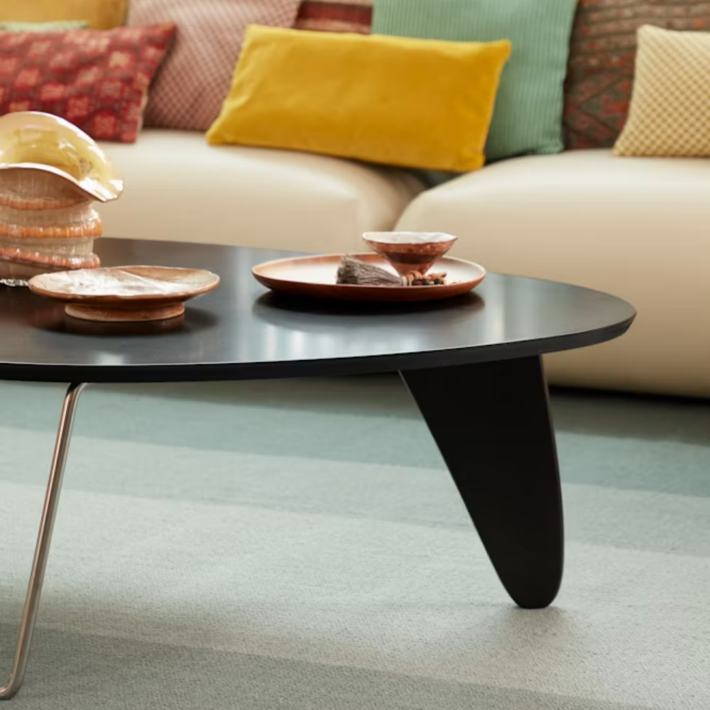 The Noguchi Rudder Coffee Table from Herman Miller in Black Ebony Maple in a living room.