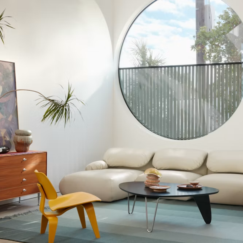 The Noguchi Rudder Coffee Table from Herman Miller in Black Ebony Maple in a living room.