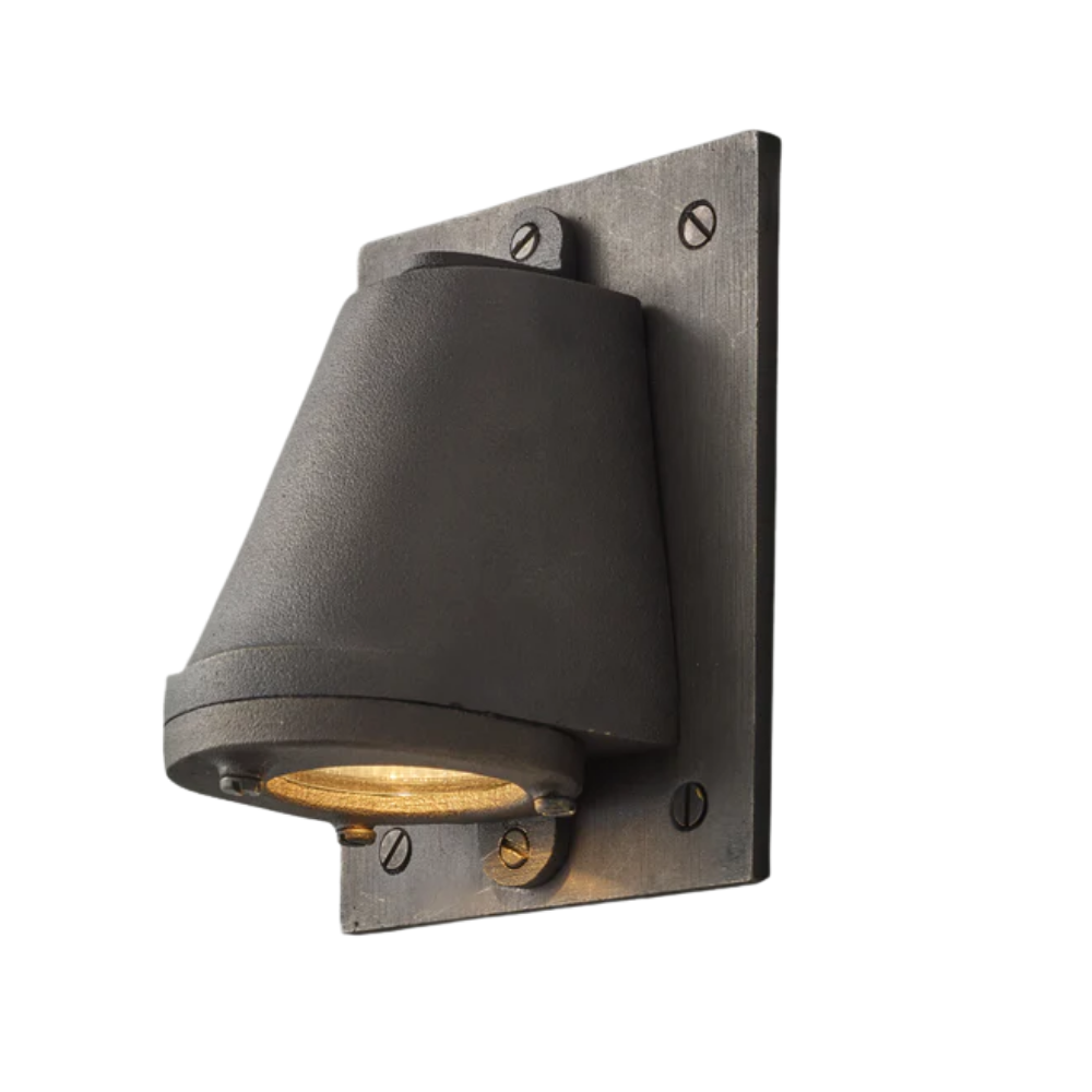 The sandblasted weathered bronze Mast Light Wall Sconce from Original BTC with a plate.