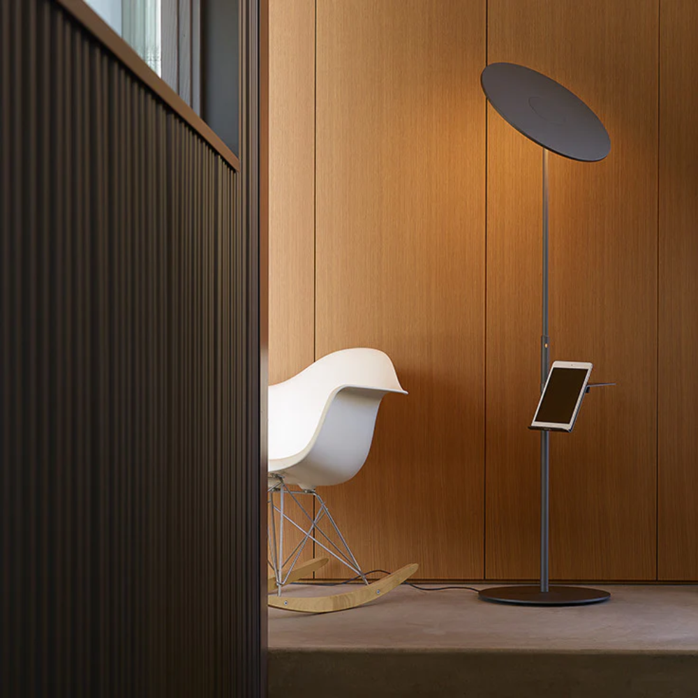 The graphite Circa Floor Lamp from Pablo Designs in a home office.