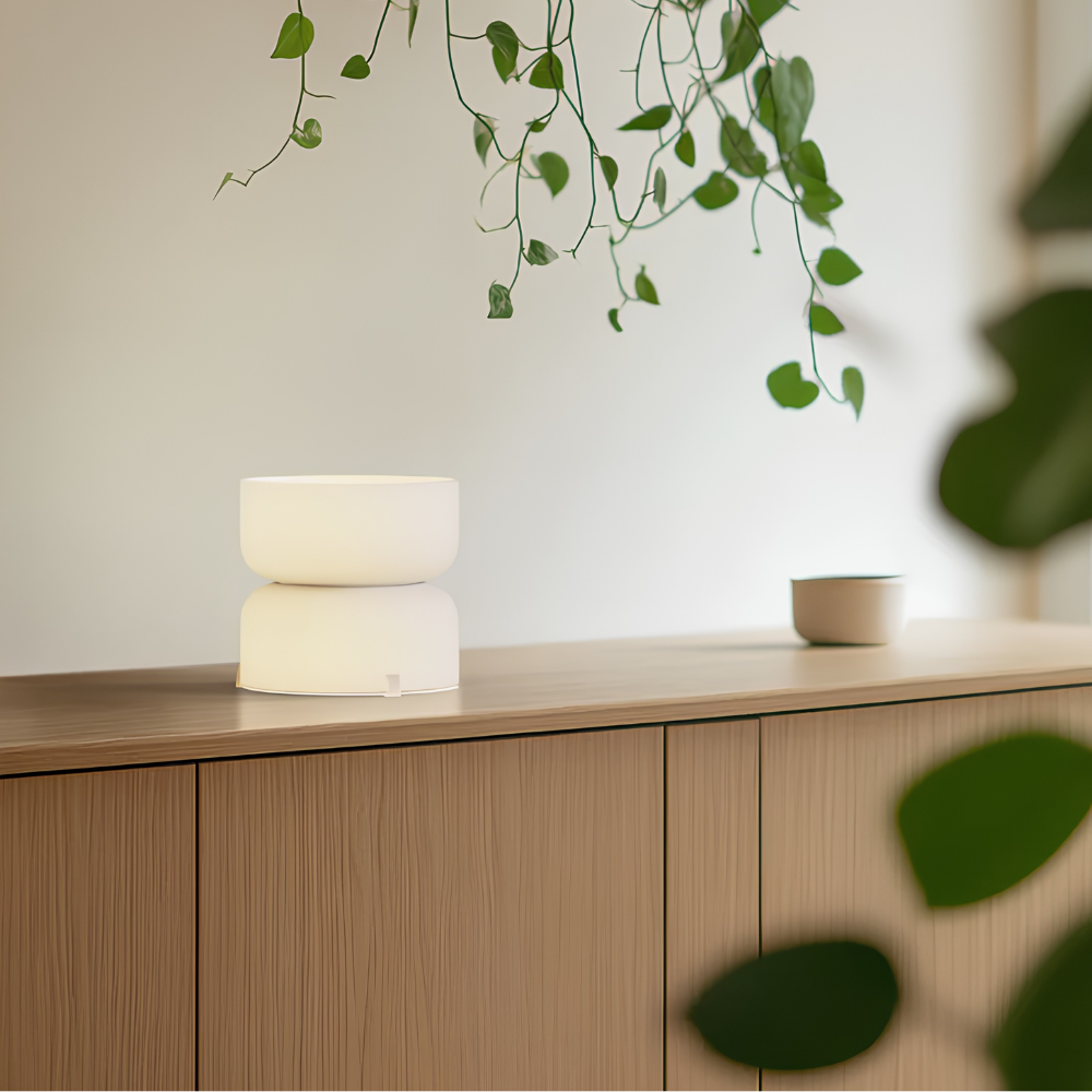 The etched white Mini Totem Table Lamp from Pablo Designs in a living room.