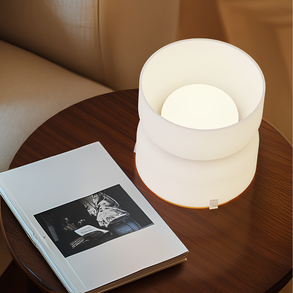 The etched white Mini Totem Table Lamp from Pablo Designs in a lounge.