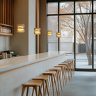 The Totem Up/Down Mini Pendant from Pablo Designs above a bar counter. all-groups