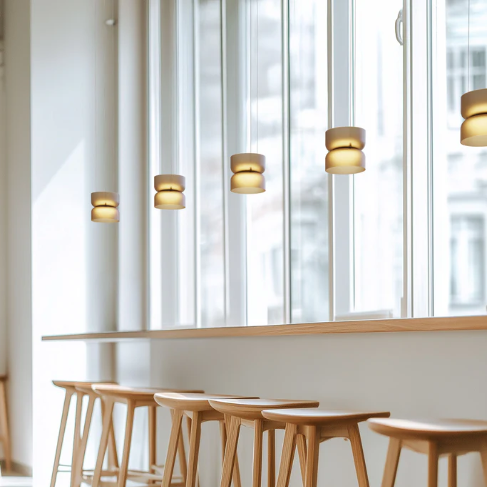 The Totem Up/Down Mini Pendant from Pablo Designs in a business space. all-groups