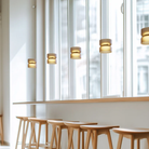 The Totem Up/Down Mini Pendant from Pablo Designs in a business space. all-groups