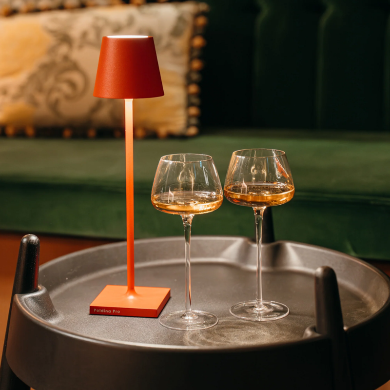 The red Poldina Pro Micro from Zafferano on an end table.