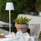 The white Poldina Pro Micro from Zafferano in an outdoor lounge.