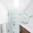 The Dimple Sconce by RBW with White Interior and Natural Anodized installed on a ceiling in a bedroom.