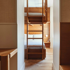 The Dimple Sconce by RBW with White Interior and Natural Anodized installed on a headboard. all-groups