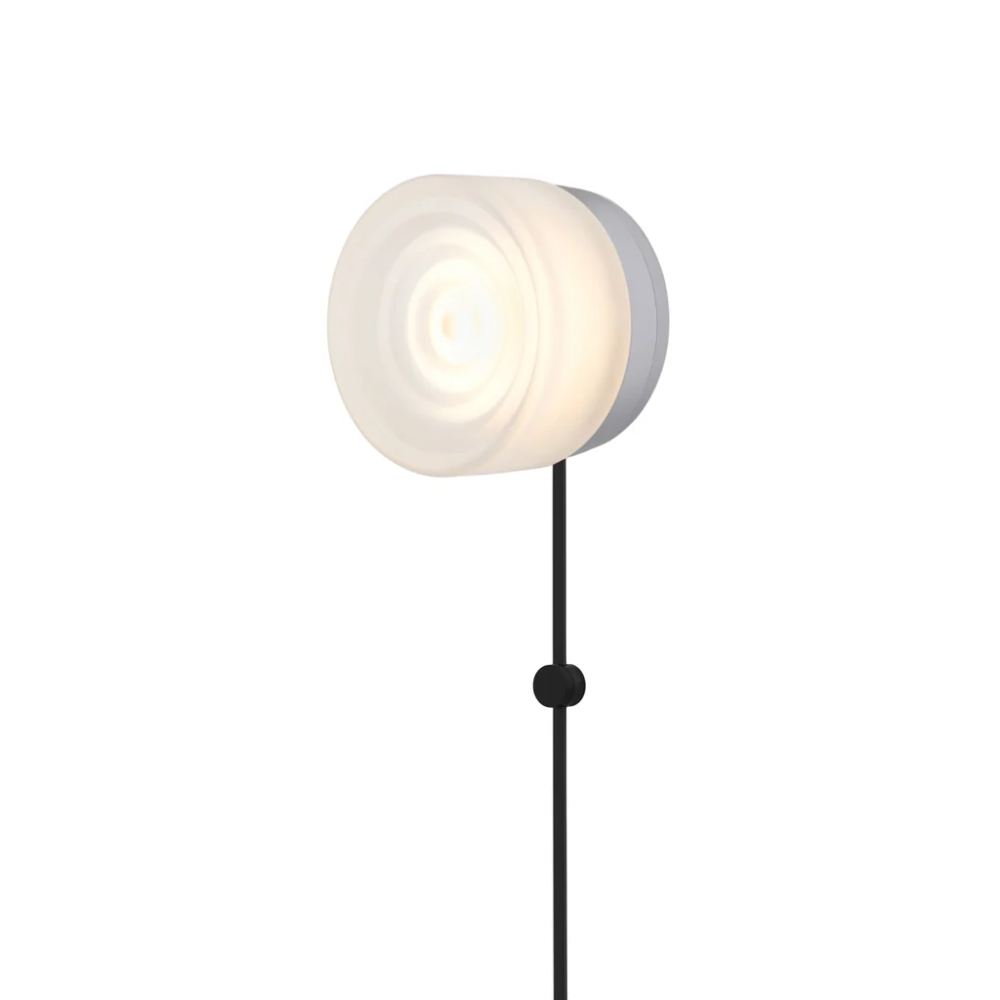 The Ripple Corded Sconce with plug-in bottom in frosted shade with natural anodized.