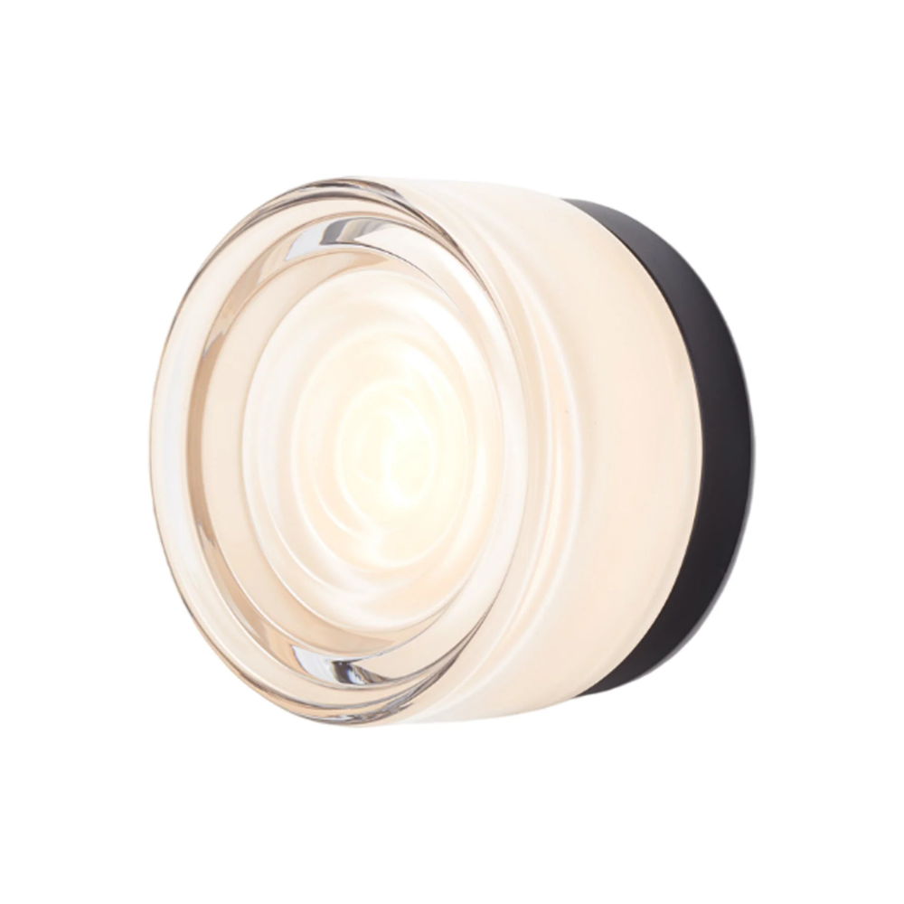 The Ripple Sconce by RBW in white interior with black anodized turned on.