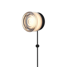 The Ripple Corded Sconce with plug-in bottom in smoke shade with black anodized.
