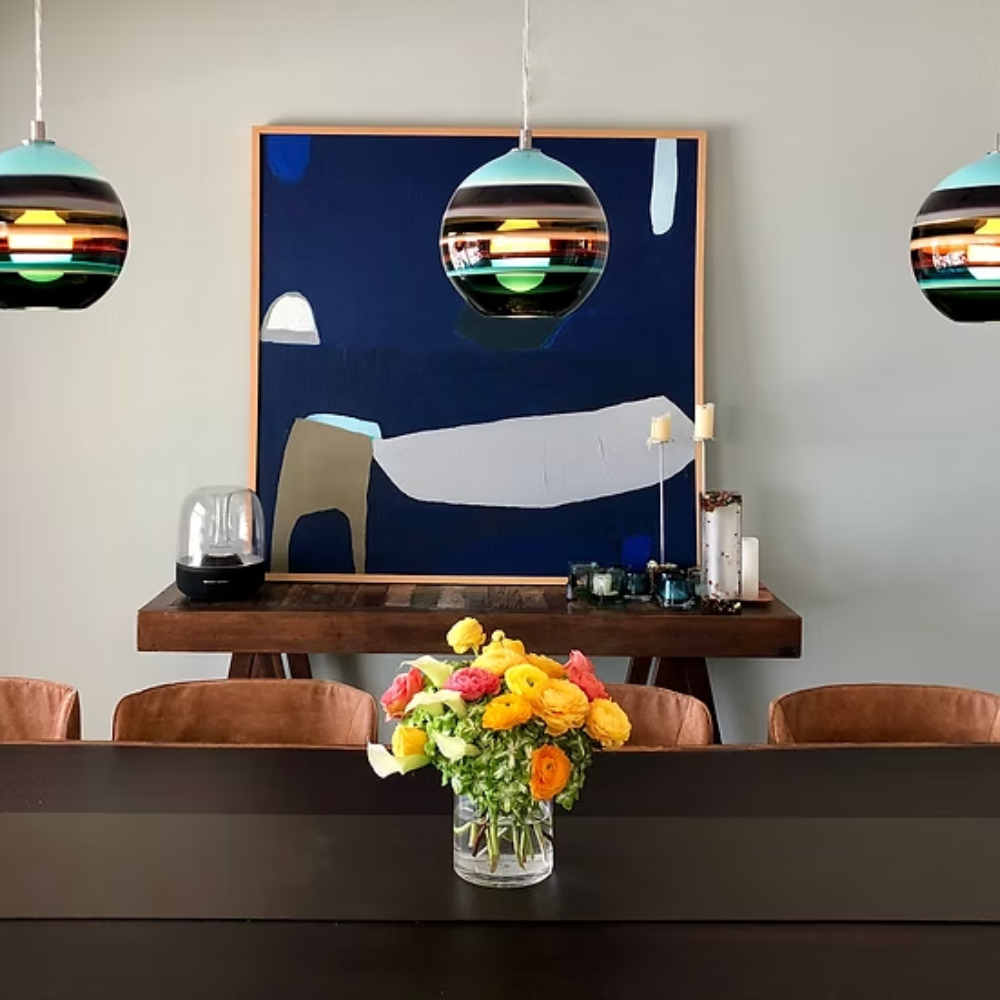 The Banded Aqua Mini Pendant from Siemon and Salazar in a dining room.