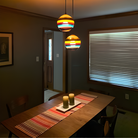 The Banded Cranberry Mini Pendant from Siemon and Salazar in a dining room.
