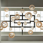 The Bubble Small Orb Clear Pendant from Siemon and Salazar is used in a business space hanging from the ceiling.