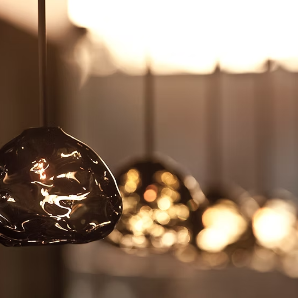 The amber Happy Small Pendant from Siemon and Salazar in a business space.