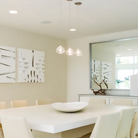 The clear Happy Small Pendant from Siemon and Salazar in a dining room.