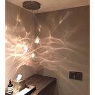 The clear Happy Small Pendant from Siemon and Salazar in a home office.
