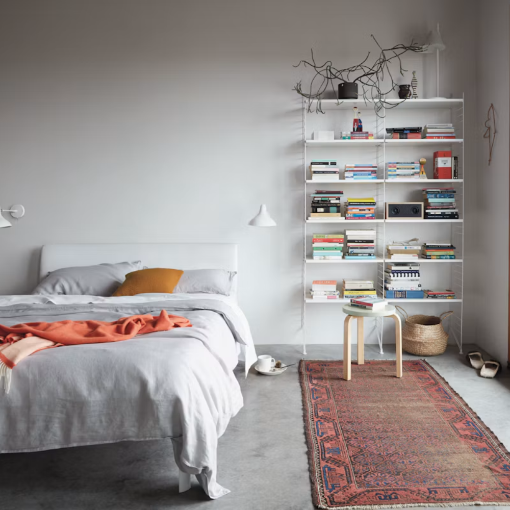 The Floor Shelving Two Bay (Living Room Bundle A) from String Furniture in white in a bedroom.