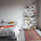 The Floor Shelving Two Bay (Living Room Bundle A) from String Furniture in white in a bedroom.