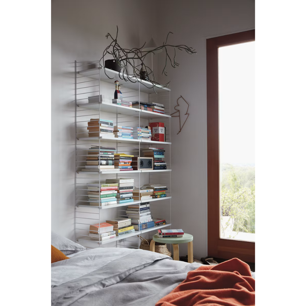 The Floor Shelving Two Bay (Living Room Bundle A) from String Furniture in white in a bedroom.