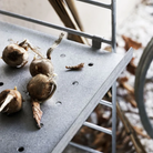 The String Outdoor galvanized metal shelf from String Furniture on a patio.
