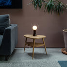 The Shore Table lamp from Tala Lighting in Brown on a side table in a living room.