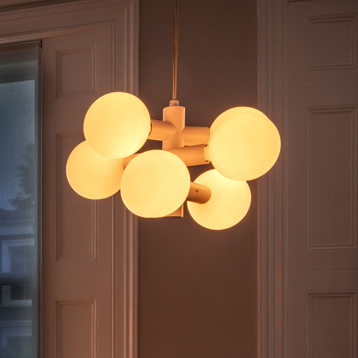 The Echo Chandelier by Tala Lighting in a living room.