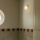 The Firth Wall Light by Tala Lighting in a bathroom.