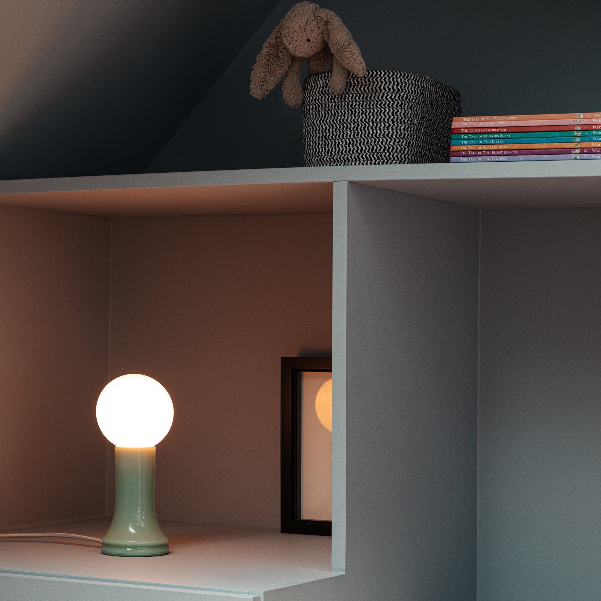 The Shore Table Lamp from Tala Lighting in Sea Green in a bedroom.