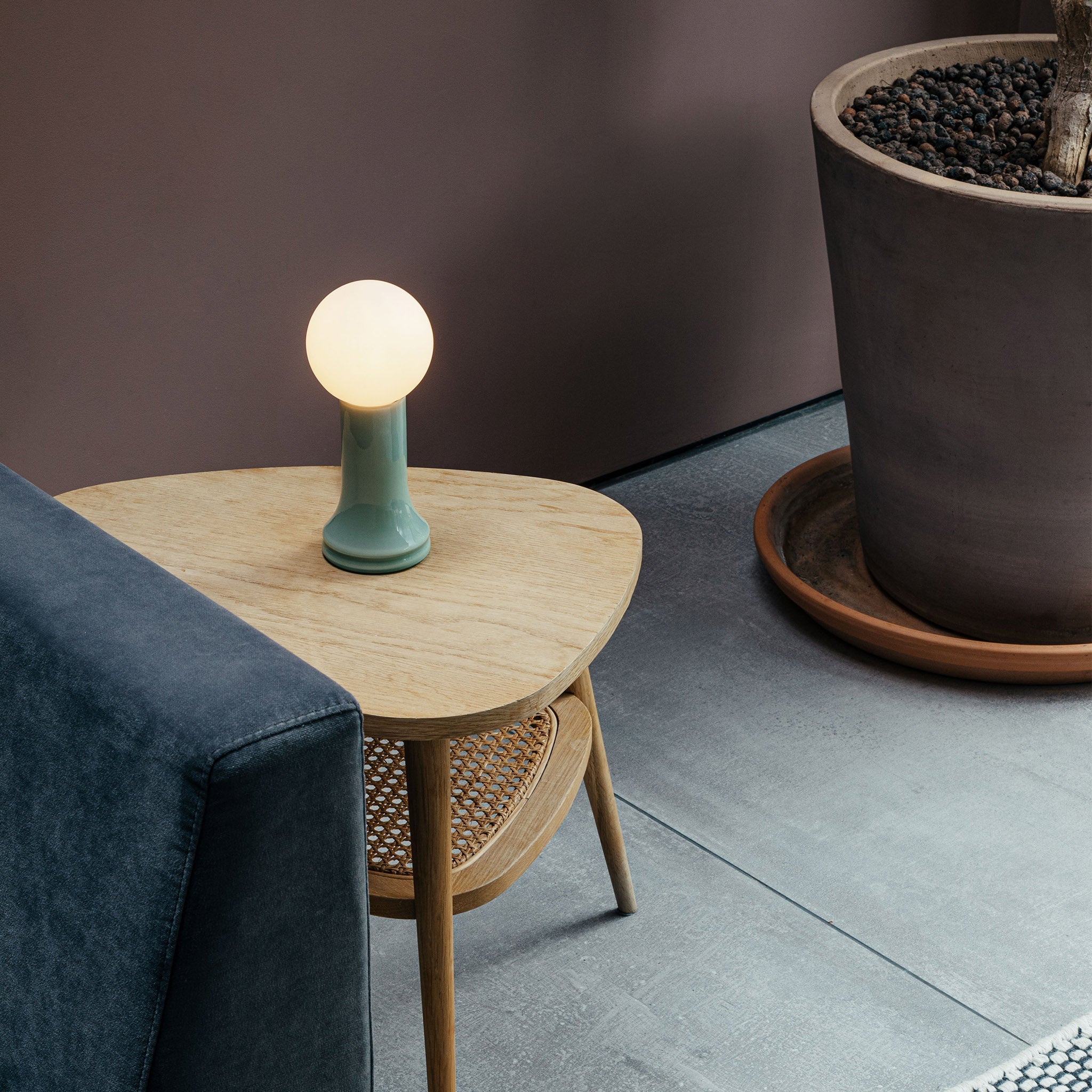 The Shore Table Lamp from Tala Lighting in Sea Green on a side table.