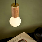 The Sphere II E26 Dim-to-Warm LED Bulb by Tala Lighting with oak pendant fitting.