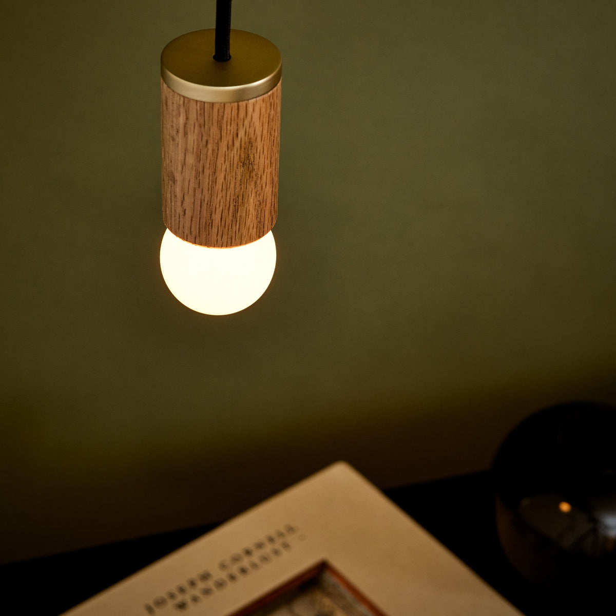 Sphere I E26 Dim-to-Warm LED Bulb by Tala Lighting in a pendant fitting.