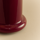 Close up of the base of the Heath Table Lamp by Tala Lighting in Port Red.