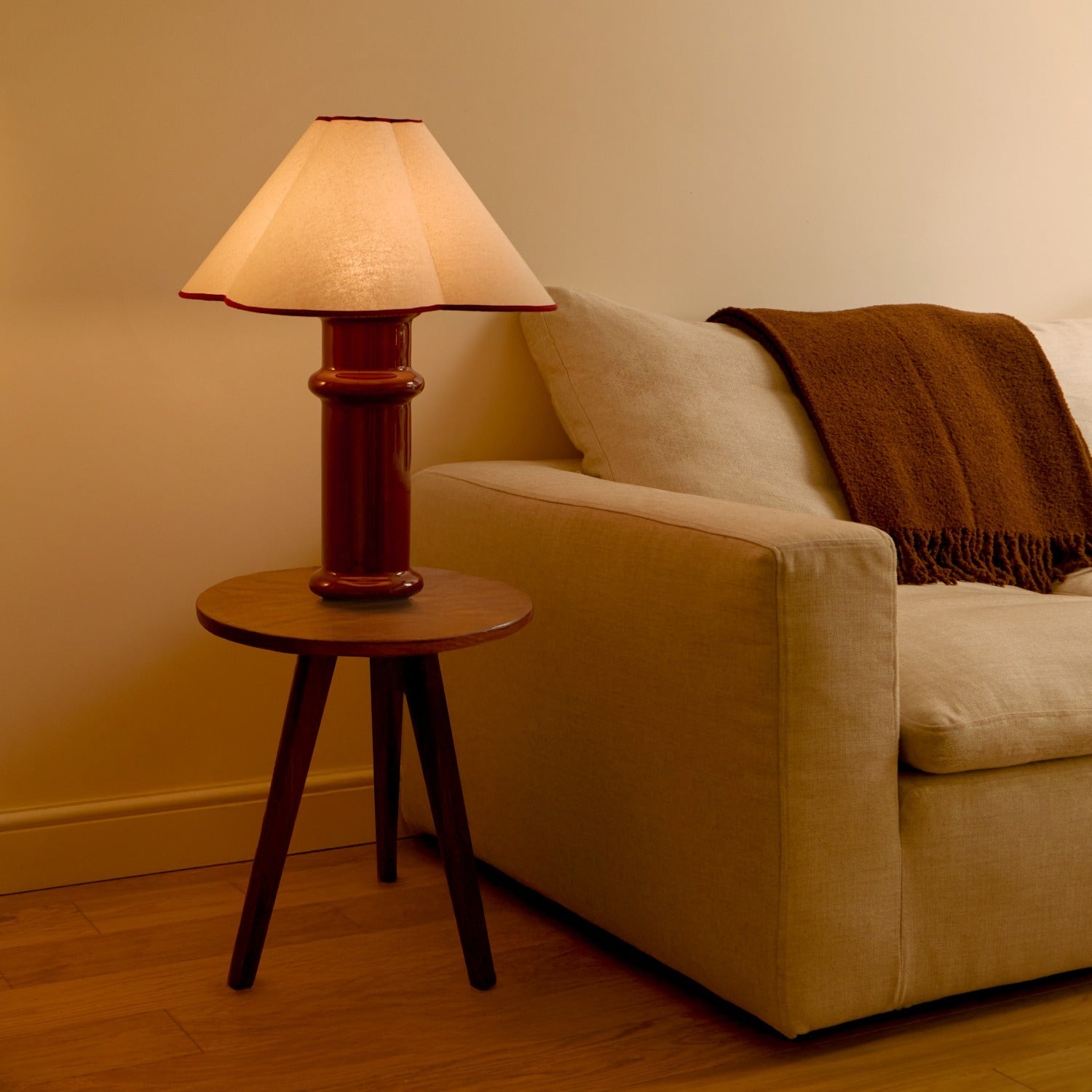 the Heath Table Lamp by Tala Lighting in Port Red in a living room.