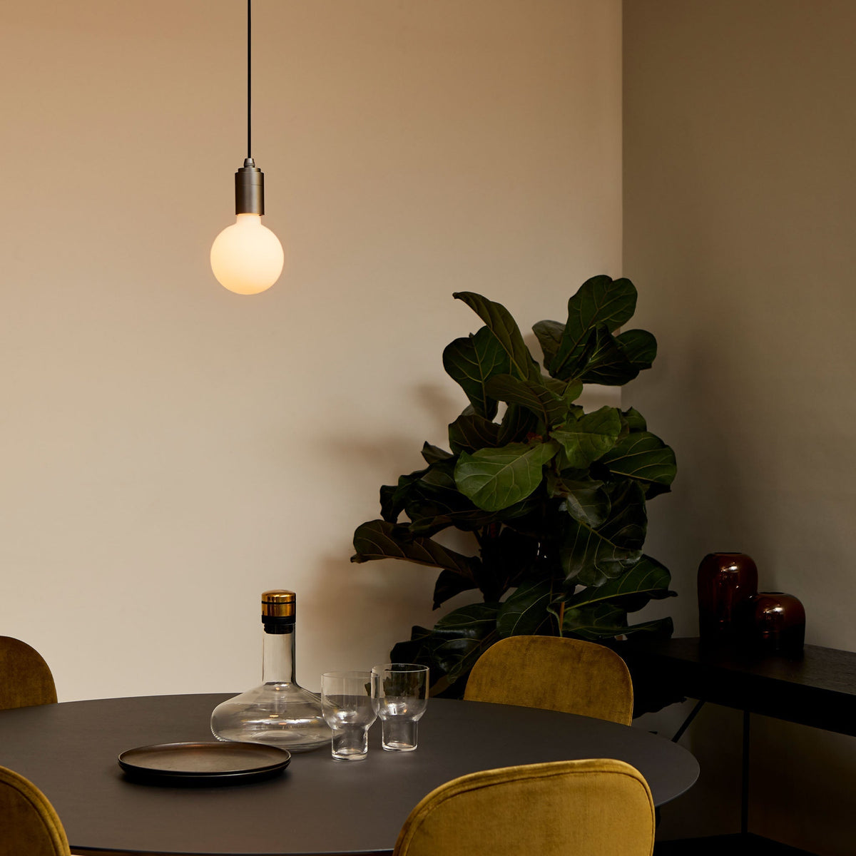The Sphere III E26 Dim-to-Warm LED Bulb by Tala Lighting in a dining room.