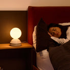 The Wake Sleep Light by Tala Lighting in pebble white in a bedroom.