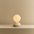 The Wake Sleep Light by Tala Lighting in pebble white turned on.