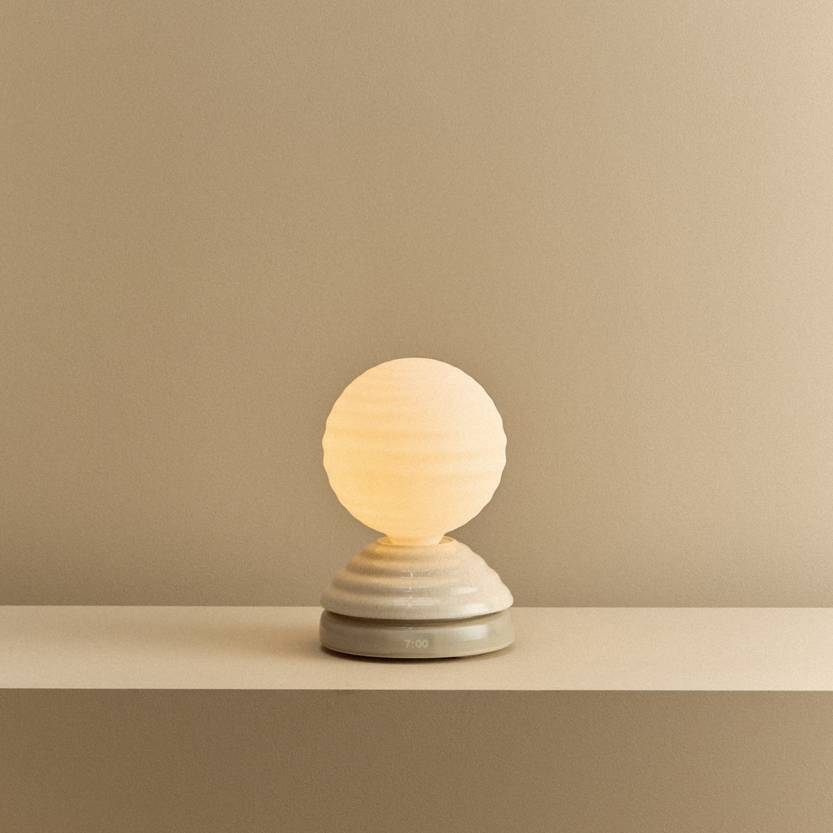 The Wake Sleep Light by Tala Lighting in pebble white turned on.