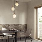 The Sphere IV E26 Dim-to-Warm LED Bulb by Tala Lighting over a table.