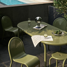 Outdoor Groove dining set in Moss by Tom Dixon on a terrace.