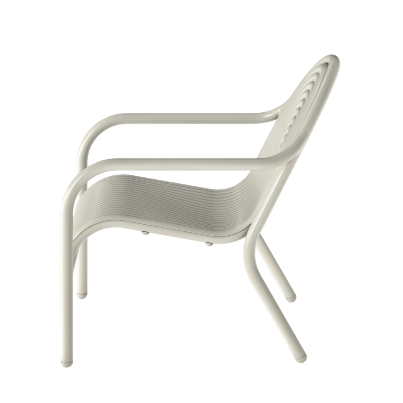 Profile view of the Groove Outdoor Lounge Chair by Tom Dixon in Putty.