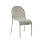 Side view of the Groove Arm Dining Chair in Putty by Tom Dixon.