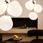 The Melt LED Small Chandelier from Tom Dixon in opal and silver in a modern living room.
