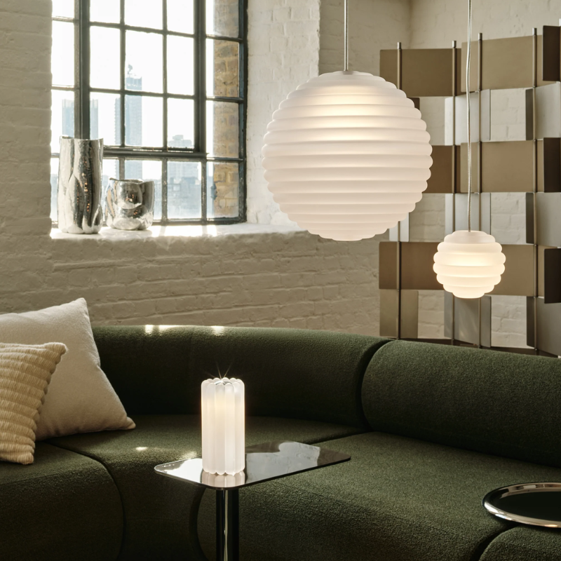 Tom Dixon Press Frosted Medium and Mini Sphere Pendants in a living room.