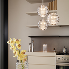 Tom Dixon Press Mini Sphere Pendants hung in a cluster in a kitchen.