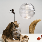 Tom Dixon Press Medium Sphere Pendant over dining table turned on.