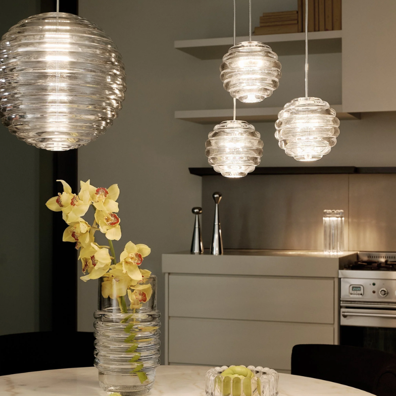 Tom Dixon Press Sphere Pendants in a kitchen and dining room.