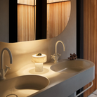 The Stone Portable Light by Tom Dixon in Brass on a bathroom vanity.